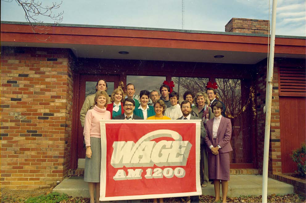 Group photo of WAGE radio employees outside the station building