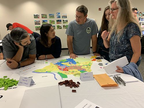 Group of people looking at a zoning map