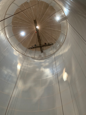 Interior view of an empty water tank during painting