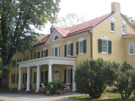 Image showing Dodona Manor the historic home of Gen. George C. Marshall. Yellow home with red roof